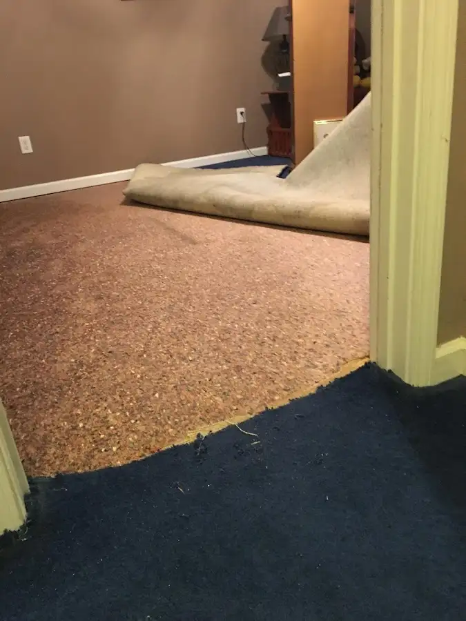 Carpet pad removal revealing water damage during Water Mitigation Services in Oxford